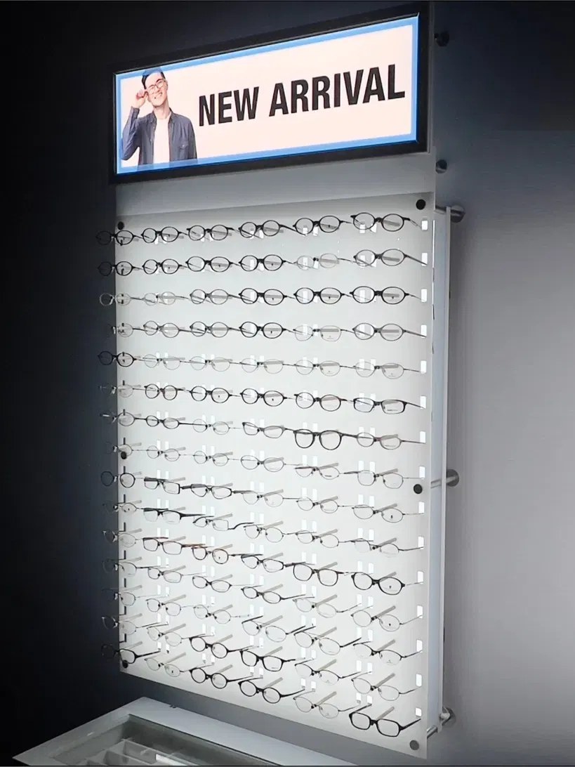 Warm-lit optical interior with illuminated shelving